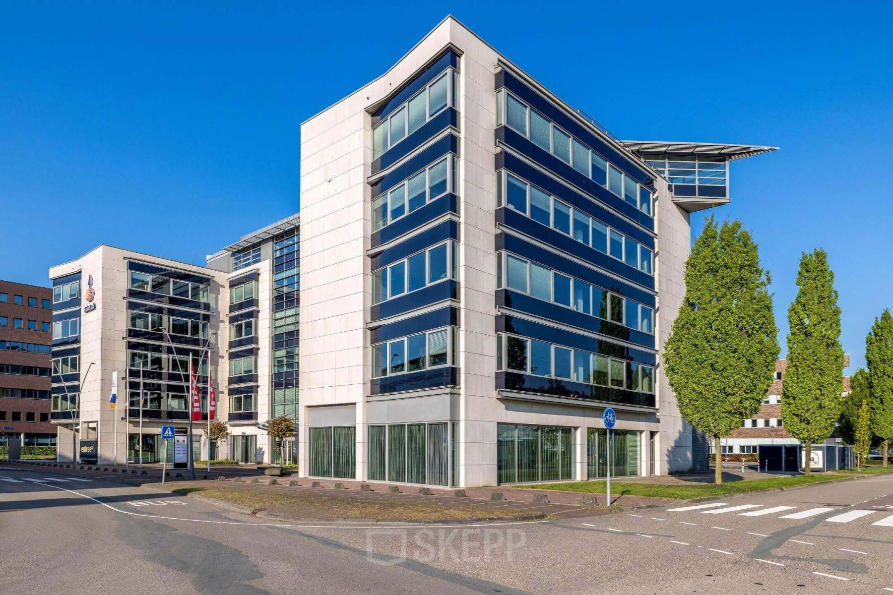 Modern office building at Meester D.U. Stikkerstraat 11 in Arnhem Zuid with large windows and a sleek design, ideal for office space rental.