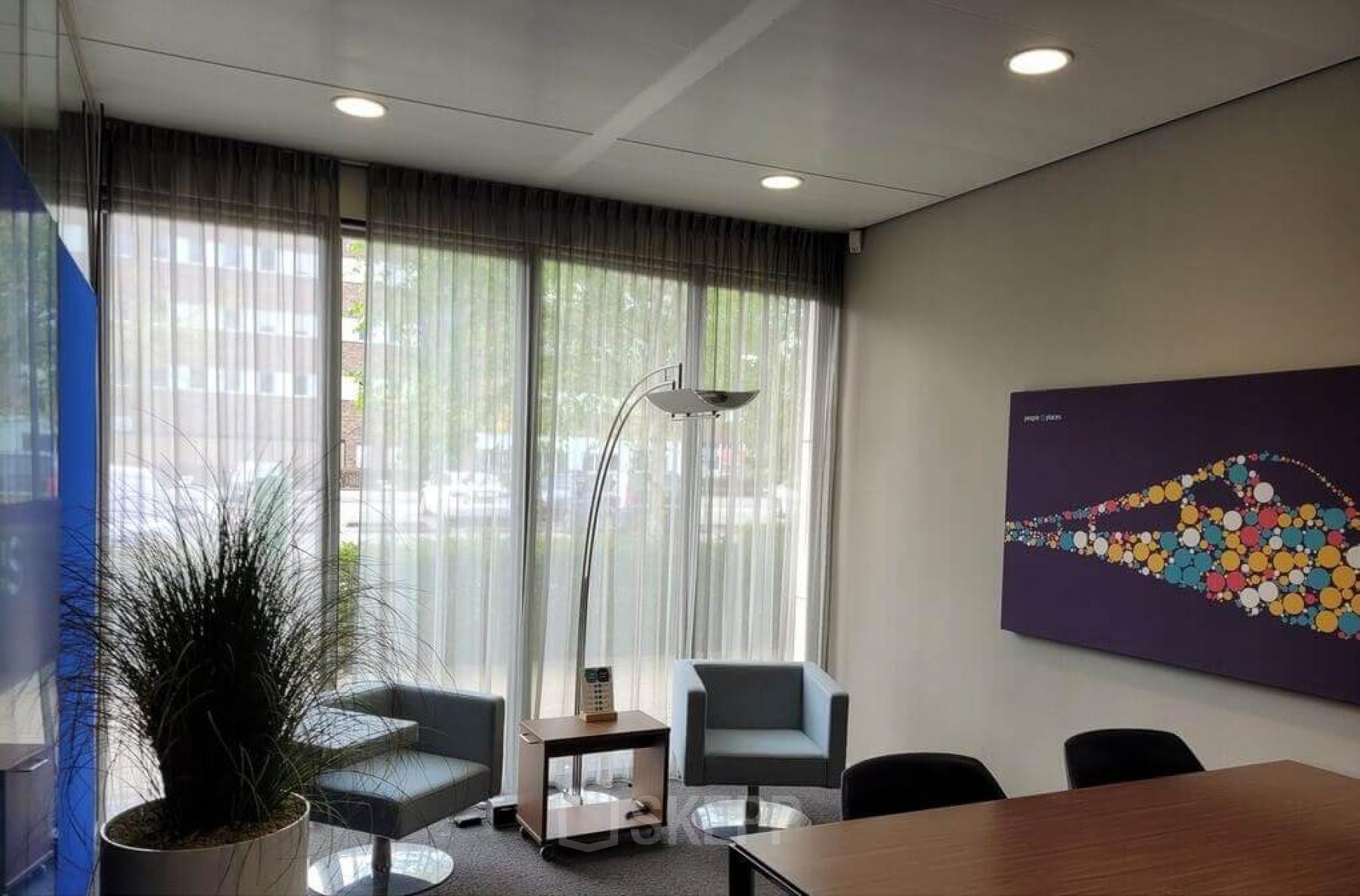 Interior of a furnished office space located at Meester D.U. Stikkerstraat 11, Arnhem Zuid, Arnhem, featuring seating area, modern decor, natural light from large windows.