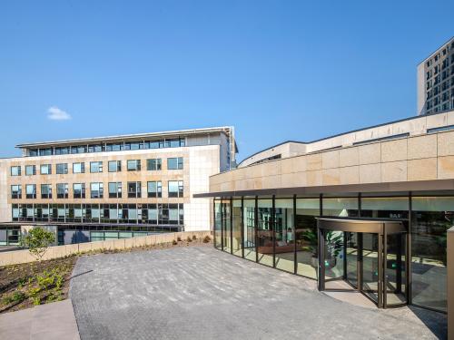 Exterior view of the office building at Rijksweg-West 2, Arnhem Zuid, Arnhem, featuring modern architecture with large windows and a clean, landscaped pathway.