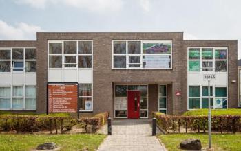 Exterior view of an office building located at Middelweg 25, Beek Lb, featuring a modern facade with large windows and surrounding greenery.
