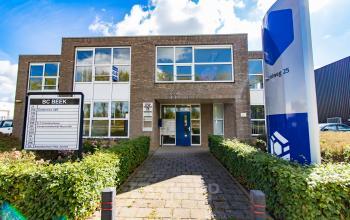 Exterior of office building at Middelweg 25, Beek Lb, featuring a modern facade with ample windows and well-maintained greenery.