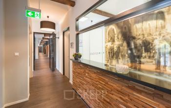 Furnished office reception area at Blokstallen 2B, Bergen op Zoom, ideal for office space rental with warm lighting and wooden accents.