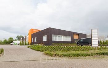 Exterior view of office building located at Poortweg 1, Bergen op Zoom, with modern design and vehicles parked outside, ideal for office space rental.