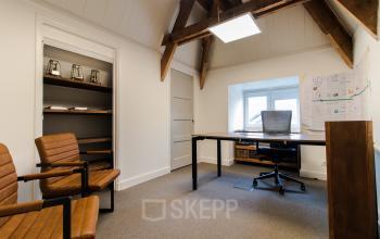 Office space with wooden beams, furnished with desk, chairs, shelves and office supplies at Prins Bernhardlaan 64, Bergen op Zoom.