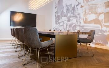 Moderner Konferenzraum im Büro Kurfürstendamm 15, Berlin Charlottenburg, mit elegantem Holztisch und stilvollen Stühlen, ideal für Meetings. Büro mieten in repräsentativer Umgebung.