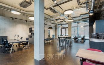 Spacious, modern office interior located at Hussitenstraße 32, Berlin Mitte, featuring large windows, contemporary furniture, and ample workspace for office space rental.