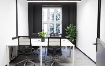 Modern eingerichtetes Büro in frischen Farben und großem Fenster