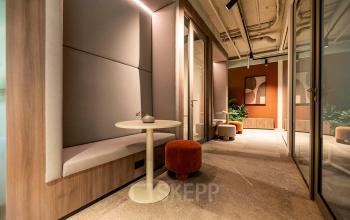 Interior of an office at De Maas 8, Best, featuring a cozy hallway with modern decor including panelled walls and stylish seating, perfect for office space rental.
