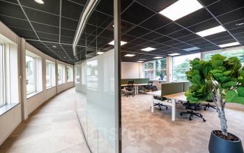 Spacious open floorplan office with modern furnishings at De Maas 8, Best. Large windows provide abundant natural light, ideal for productivity. Perfect for those seeking office space rental in a professional setting.