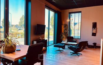 Modern office space at Deltazijde 20b, Blaricum, featuring floor-to-ceiling windows, sleek furniture, and a stylish interior, perfect for office space rental.