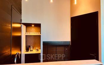 Cozy and modern pantry area at Deltazijde 20b, Blaricum. Features include a sleek coffee machine and warm lighting, ideal for office space rental needs.