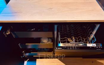 Modern pantry area at Deltazijde 20b, Blaricum featuring sleek cabinetry and a built-in dishwasher. Ideal for office space rental, enhancing convenience in a business setting.