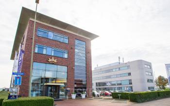 Exterior view of office buildings located at Tolnasingel 1 - 3 in Bodegraven, Bodegraven, with modern architecture and ample parking space visible.