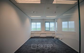Unfurnished office space rental with large windows offering natural light and scenic views at Tolnasingel 1-3, Bodegraven.
