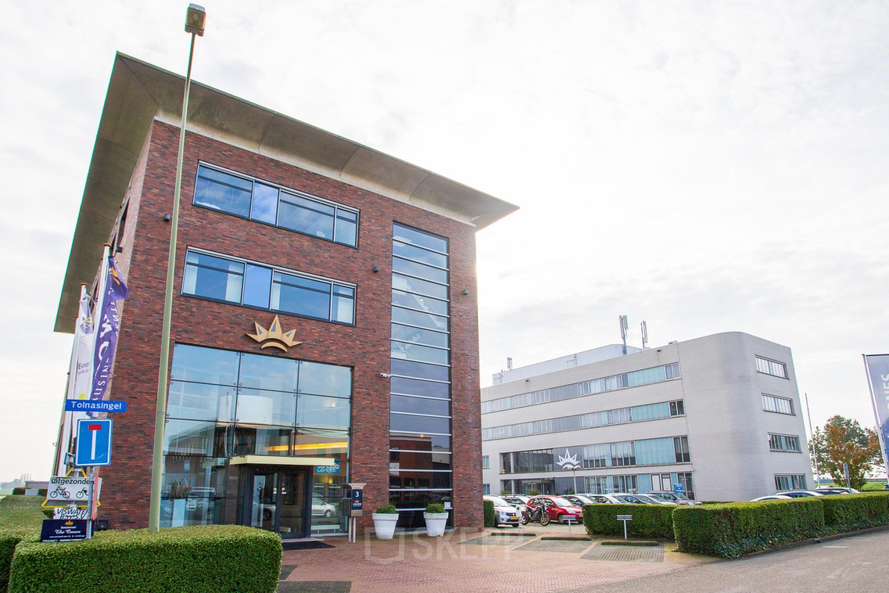 Exterior view of office buildings located at Tolnasingel 1 - 3 in Bodegraven, Bodegraven, with modern architecture and ample parking space visible.