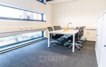 Bright office with a spacious table and modern chairs at Ceresstraat 1, ideal for rent office space. Large windows provide natural light, enhancing the inviting environment.