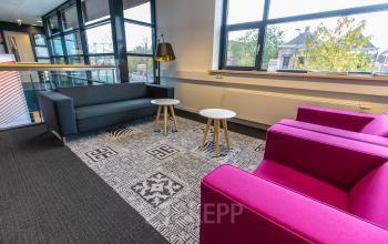 Bright office lounge area with colorful seating and natural light, situated at Ceresstraat 1 in Breda Centrum-Station, ideal for office space rental.