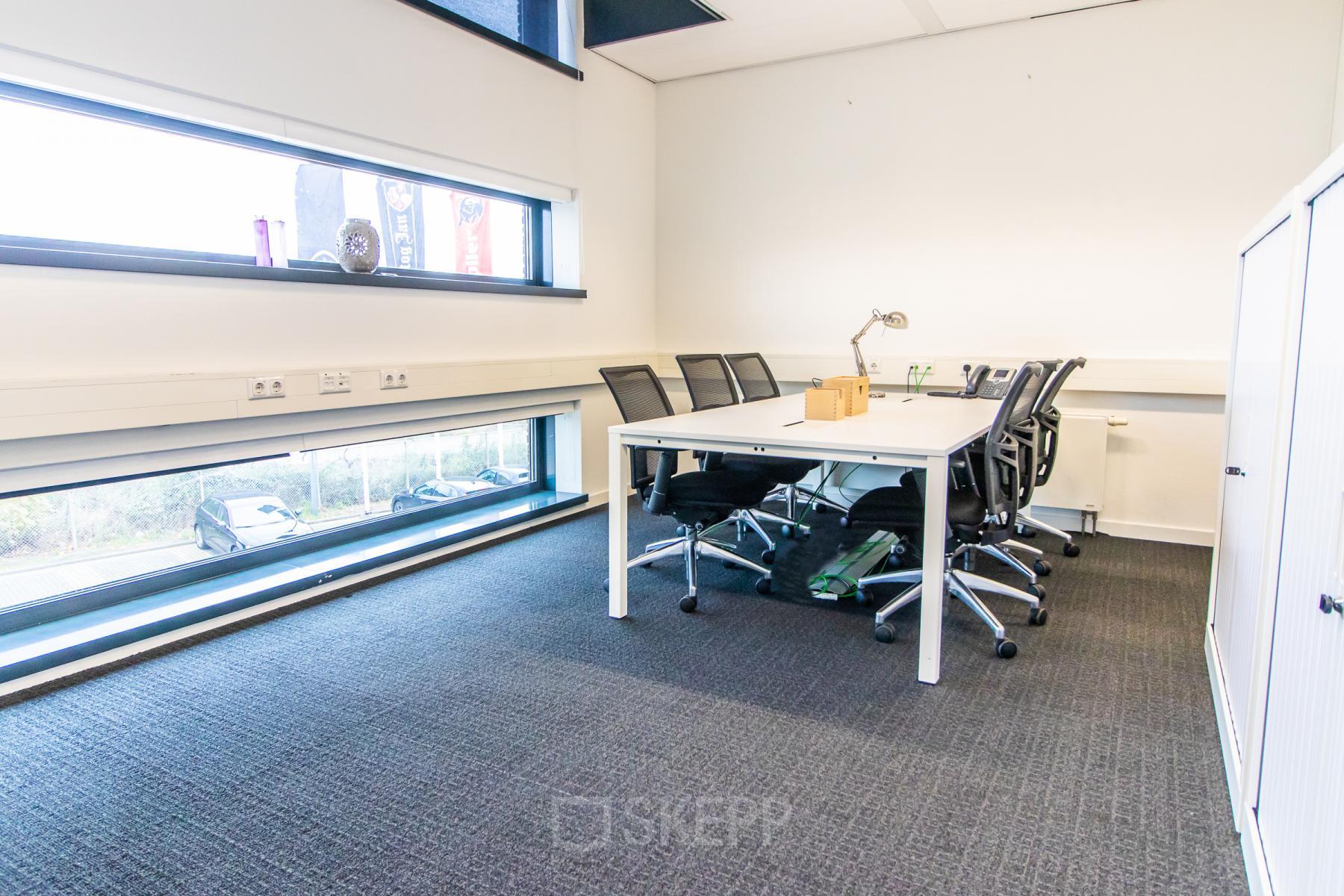 Bright office with a spacious table and modern chairs at Ceresstraat 1, ideal for rent office space. Large windows provide natural light, enhancing the inviting environment.