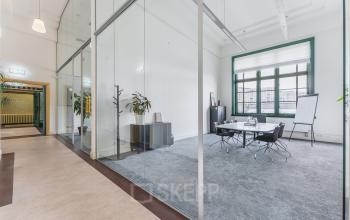 Bright office space to rent at Ceresstraat 13, Breda Centrum-Station, featuring glass walls, a conference table, and chairs, suitable for office space rental.
