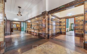 Interior view of an office space at Ceresstraat 13, Breda Centrum-Station, showcasing a tiled hallway with visible doors leading to different rooms, offering potential for office space rental.