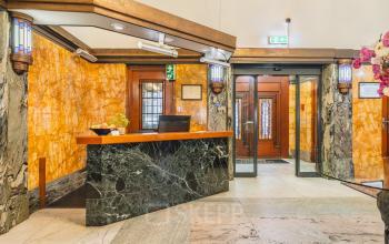 Interior view of a stylish office space rental at Ceresstraat 13, Breda Centrum-Station, featuring a welcoming reception desk with a modern design.