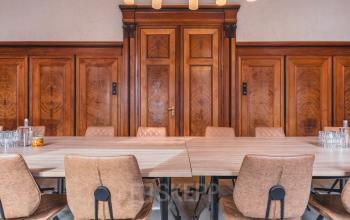 A tastefully furnished office meeting room at Ceresstraat 13 in Breda Centrum-Station with a large table and chairs, suitable for office space rental.