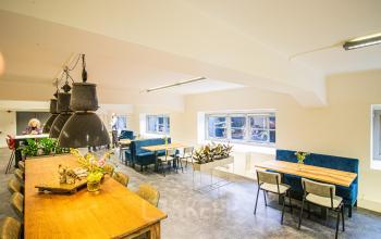 Bright and inviting office space rental at Ceresstraat 13 in Breda Centrum-Station featuring workstations and a cozy breakout area.