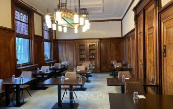 Elegant office space rental at Ceresstraat 13, Breda Centrum-Station with wooden paneling and arranged tables for professional meetings.