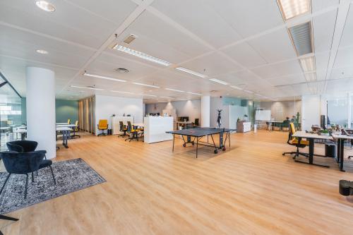Spacious and modern open floor plan at Heerbaan 14, Breda Oost-Brabantpark, featuring sleek workspaces and a stylish lounge area ideal for office space rental.