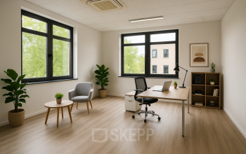 Bright, minimalistic office space with large windows, a desk, chair, and small table in Breda Oost. Ideal for rent office space seekers.
