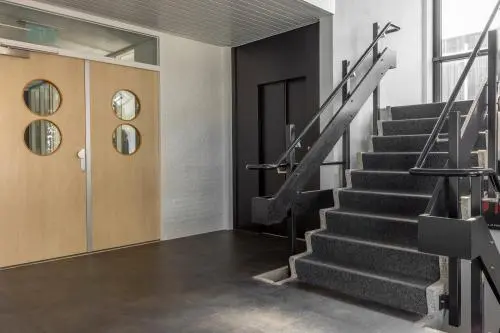 Interior view at Druivenstraat 25-31 in Breda Oost featuring a staircase and elevator, ideal for office space rental.