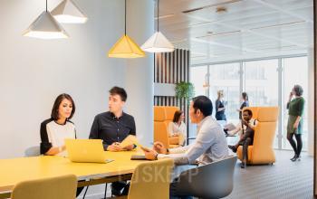 Modern office space at Leonardo Da Vincilaan 1 in Brussels Airport featuring people in collaborative business activities.