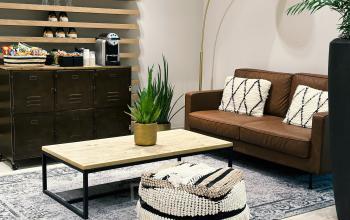 Comfortable lounge area at Leonardo Da Vincilaan 19, Brussels Airport, featuring a cozy leather sofa, coffee table, and a snack corner. Ideal for office space rental.