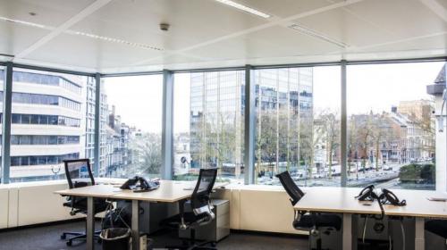 Bright office space with desks and phones overlooking the city, ideal for office space rental at Louizalaan / Avenue Louise 480, Brussels Elsene.