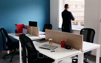 Modern office space for rent at Louizalaan / Avenue Louise 367, Brussels Elsene, featuring workstations and a person looking out the window.