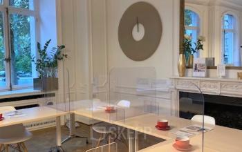 Elegant office space rental at Louizalaan / Avenue Louise 367 in Brussels Elsene, featuring modern furnishings, protective screens, and large windows for natural light.