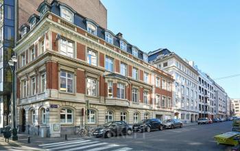 Exterior view of the office building at Louizalaan / Avenue Louise 367, in Brussels Elsene, Brussels, with street and parked cars.