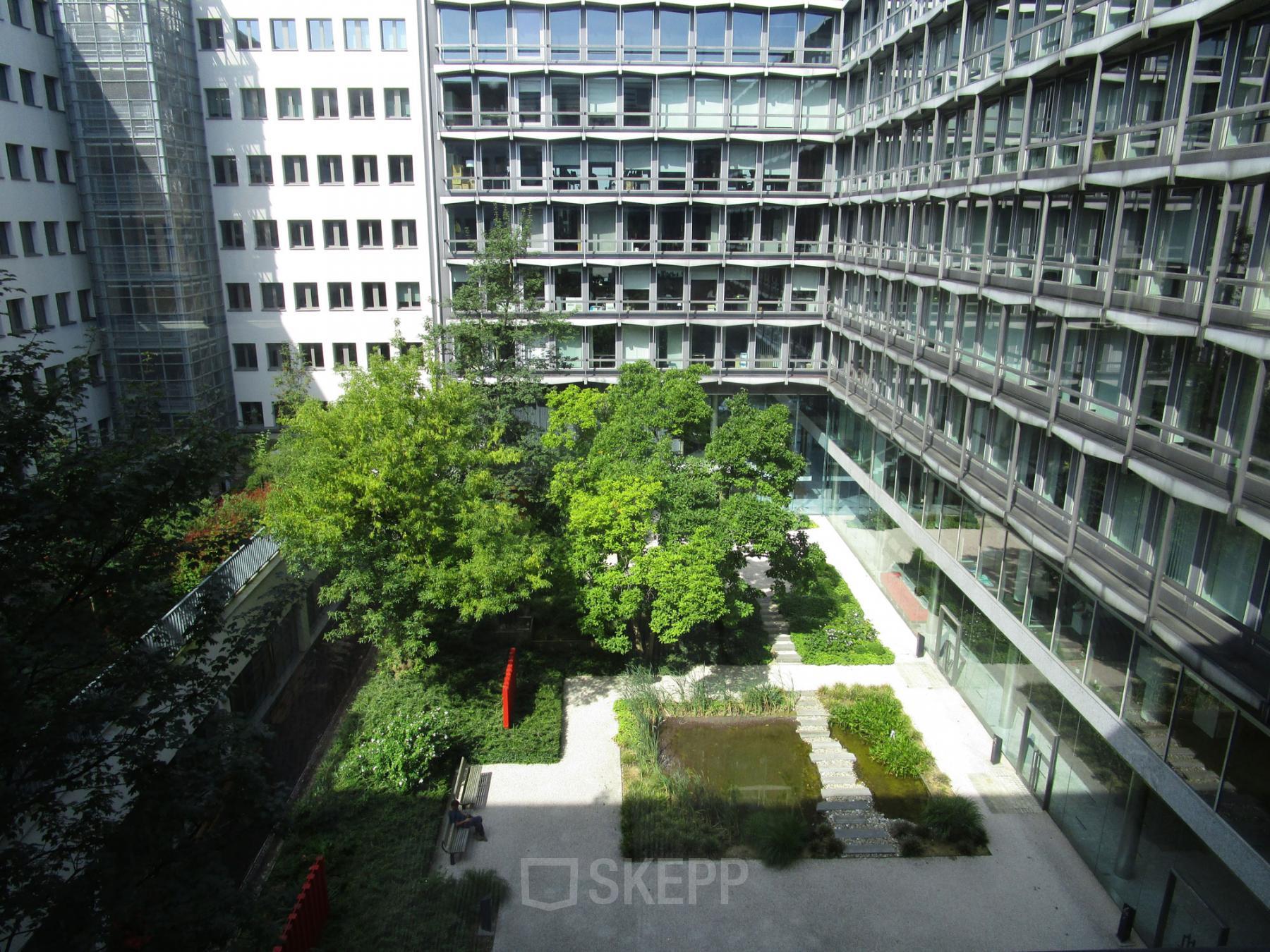 Exterior view of the office building at Kunstlaan / Avenue des Arts 56, Brussels European District, featuring a landscaped courtyard.