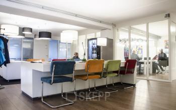 Contemporary office space rental at Kanaalweg 33, Capelle aan den IJssel, with colorful chairs and a relaxed business ambiance.