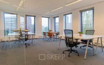 Spacious office with multiple desks and chairs, natural light from large windows, available for office space rental at Fascinatio Boulevard 562, Capelle aan den IJssel.