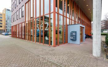 Exterior view of office building at Fascinatio Boulevard 562 in Capelle aan den IJssel, showcasing large glass windows and a visible entrance.