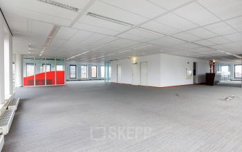 Spacious interior of an office to rent at Fascinatio Boulevard 562, Capelle aan den IJssel, featuring large windows and a neutral color scheme, ready for office space rental customization.