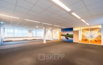 Spacious and well-lit office space for rent at Rhijnspoor 209-263, Capelle aan den IJssel, featuring large windows and modern interiors.