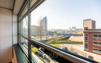 View from an office window at Fascinatio Boulevard 522, Capelle aan den IJssel, showcasing the cityscape. Ideal for those looking to rent office space with a bright and lively environment.