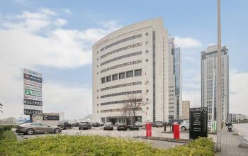 Modern office building at Rivium Quadrant 75, Capelle aan den IJssel, offering ample parking and spacious facilities for office space rental. The sleek architecture complements the business environment.