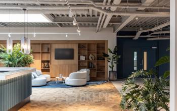 Modern furnished office space rental at Essebaan 63, Capelle aan den IJssel, featuring a stylish lounge area with contemporary seating and decorative elements.