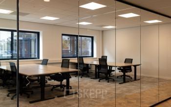 Spacious office to rent at Essebaan 63, Capelle aan den IJssel, featuring multiple workstations and natural light through large windows.