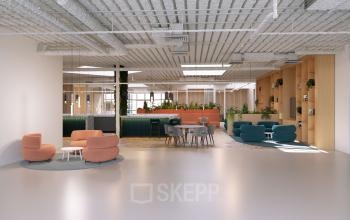 Modern open office space at Essebaan 63-69, Capelle aan den IJssel, featuring stylish seating areas, contemporary tables, and lush greenery, ideal for office space rental. The design promotes a collaborative atmosphere.
