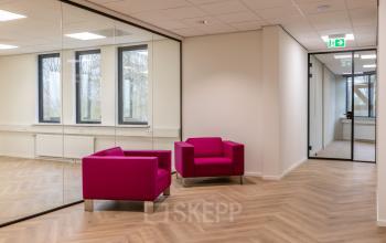 Modern furnished office space with vibrant purple chairs and glass walls at Vlierbaan 20, perfect for rent office space in Capelle aan den IJssel.