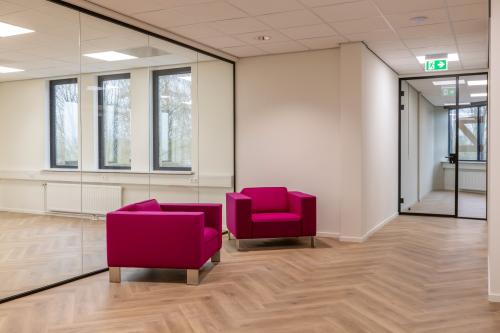 Modern furnished office space with vibrant purple chairs and glass walls at Vlierbaan 20, perfect for rent office space in Capelle aan den IJssel.